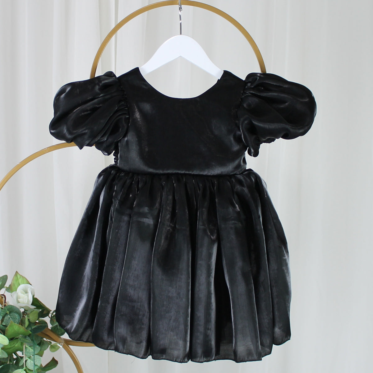 black flower girl dress with puffy sleeves and big bow. 