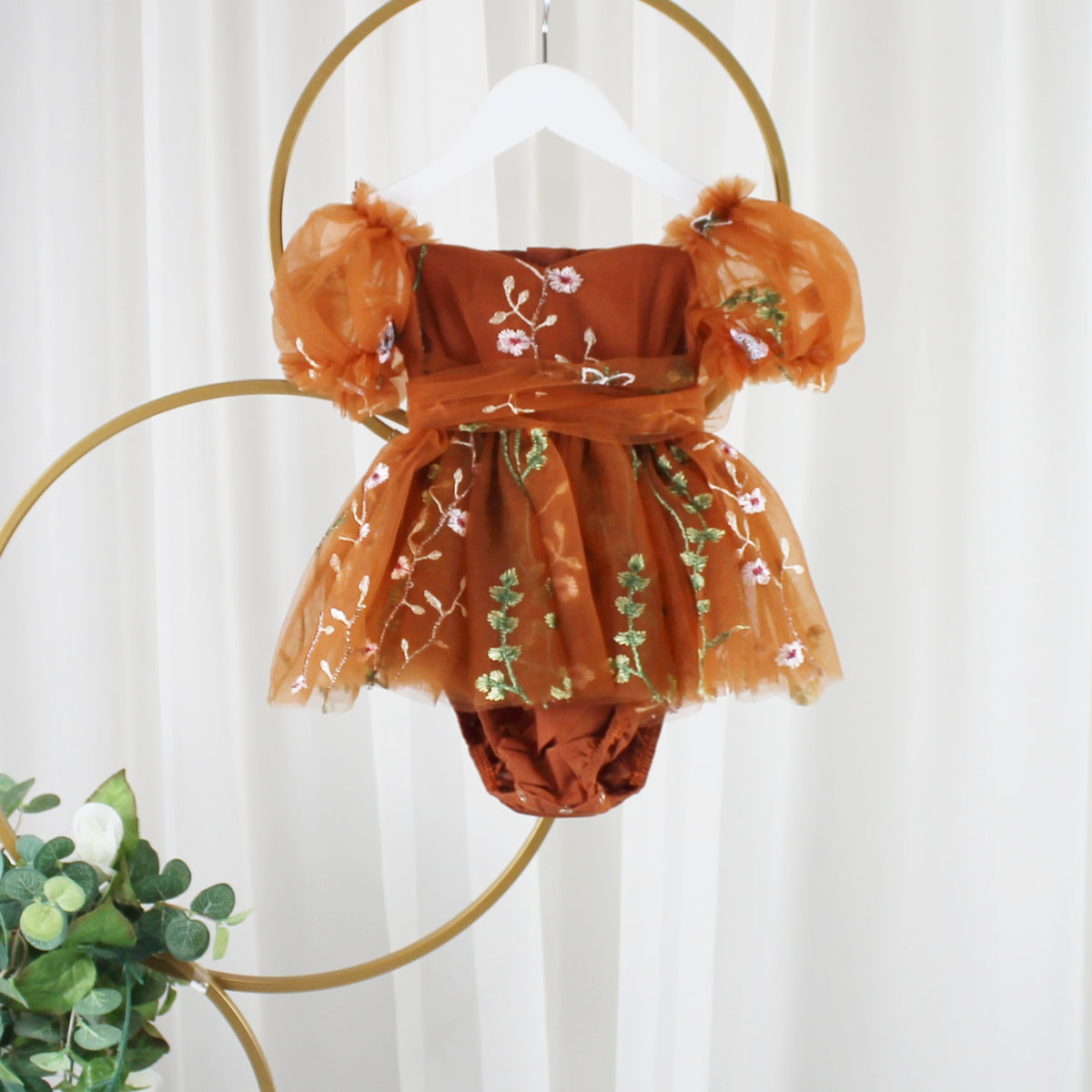Baby fall dress in burnt orange with floral embroidery and built-in bodysuit