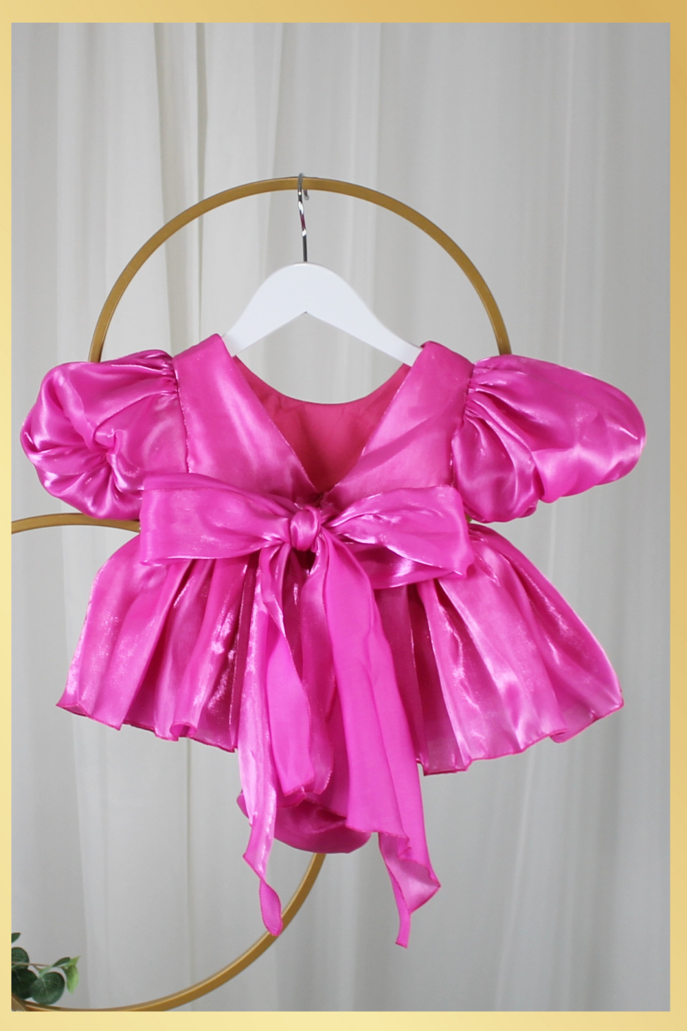 baby girl dress in fuchsia pink. Big puffy sleeves in romper style Organza shiny material. For first birthdays and flower girl dresses for weddings