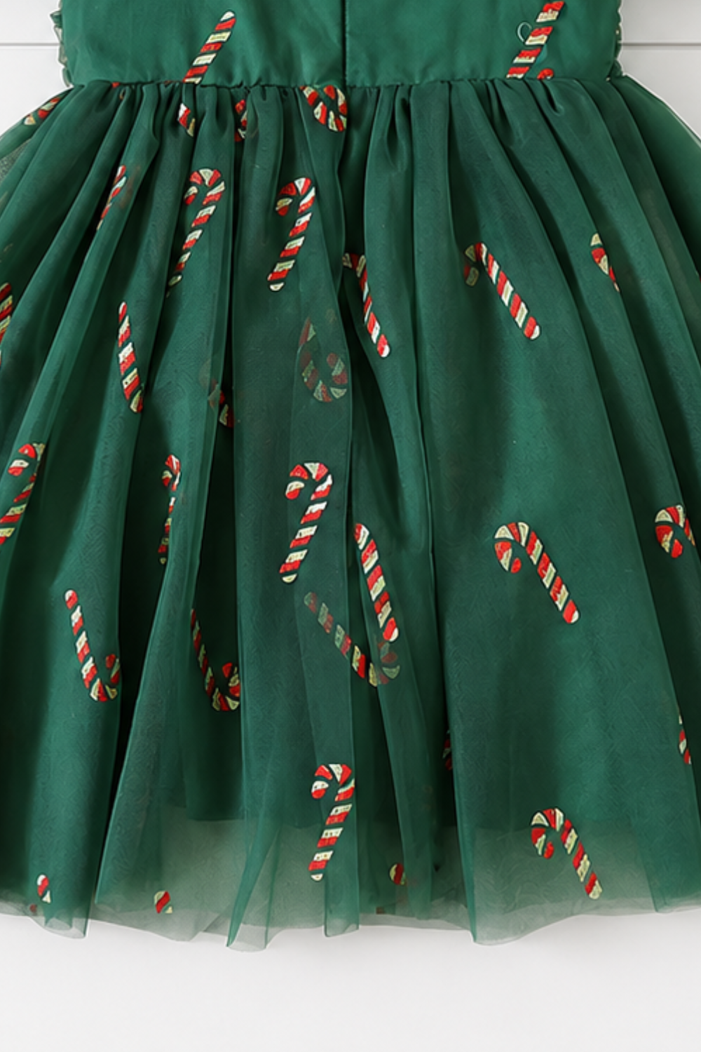 Girls holiday dress featuring green tulle, red and gold glitter candy canes, sweetheart neckline and layered skirt.