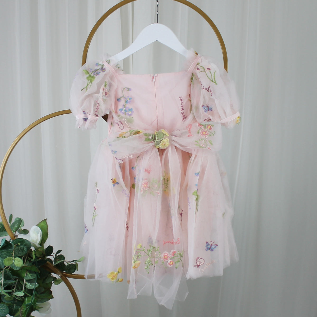 1st birthday baby girl romper in light pink floral for a fairy or garden party theme. 